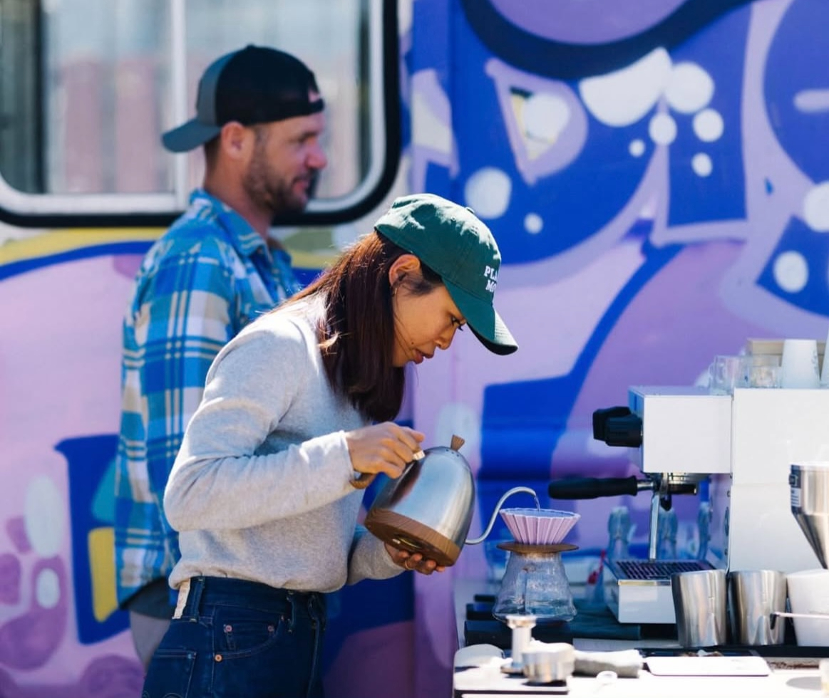 Woman making pour-over coffee.