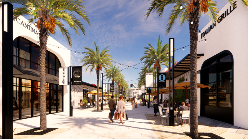 A store-lined sidewalk through an outdoor mall.