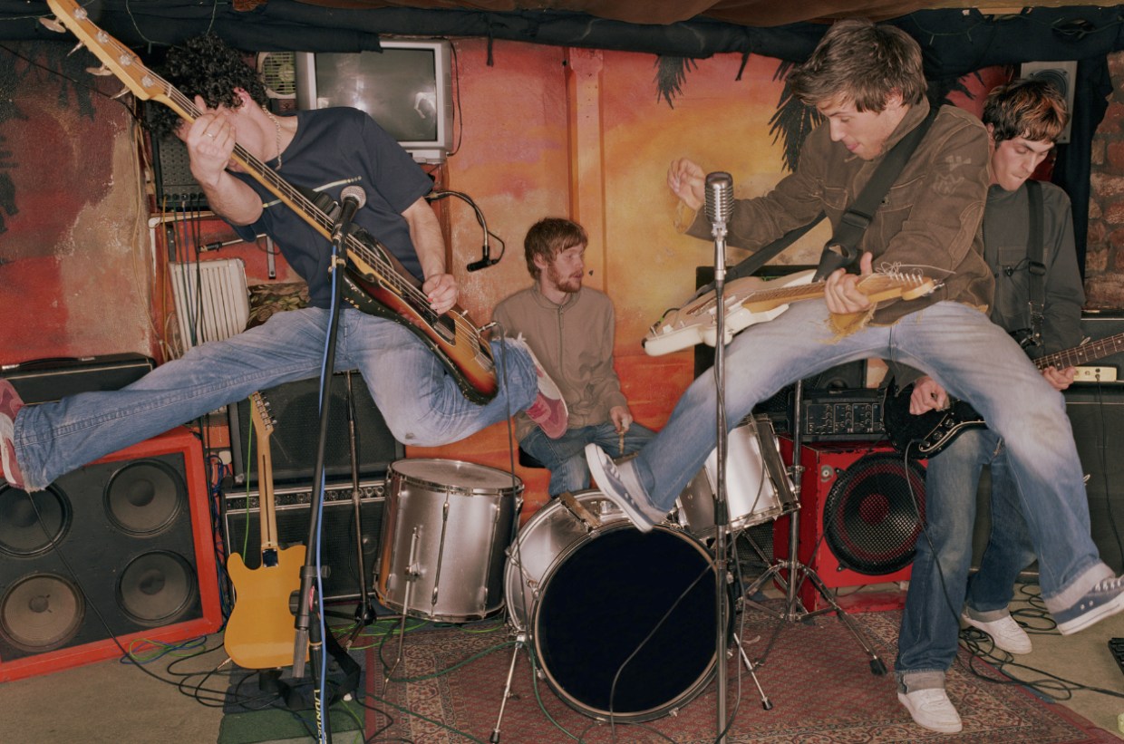 Multiple musicians rehearse in garage
