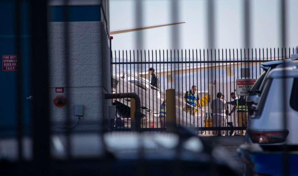 A detainee boards a 747 that is part of Immigration and Customs Enforcement’s Air Operations at Mesa Gateway Airport on Sept. 23, 2025.