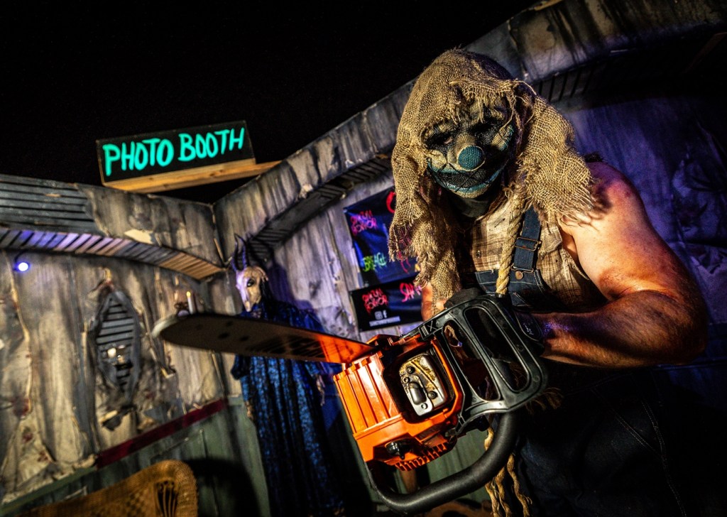 Masked man with a chainsaw.