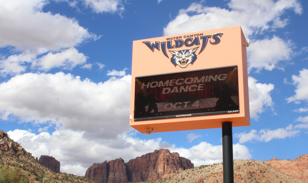 a sign for water canyon high school advertising the homecoming dance