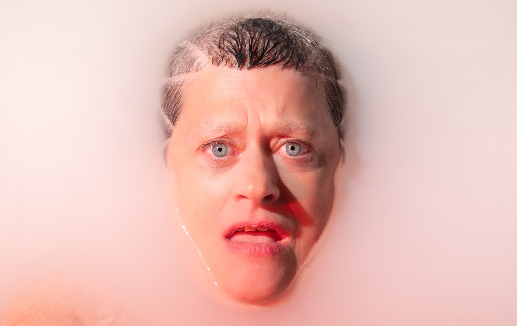 A woman face up in bathwater.