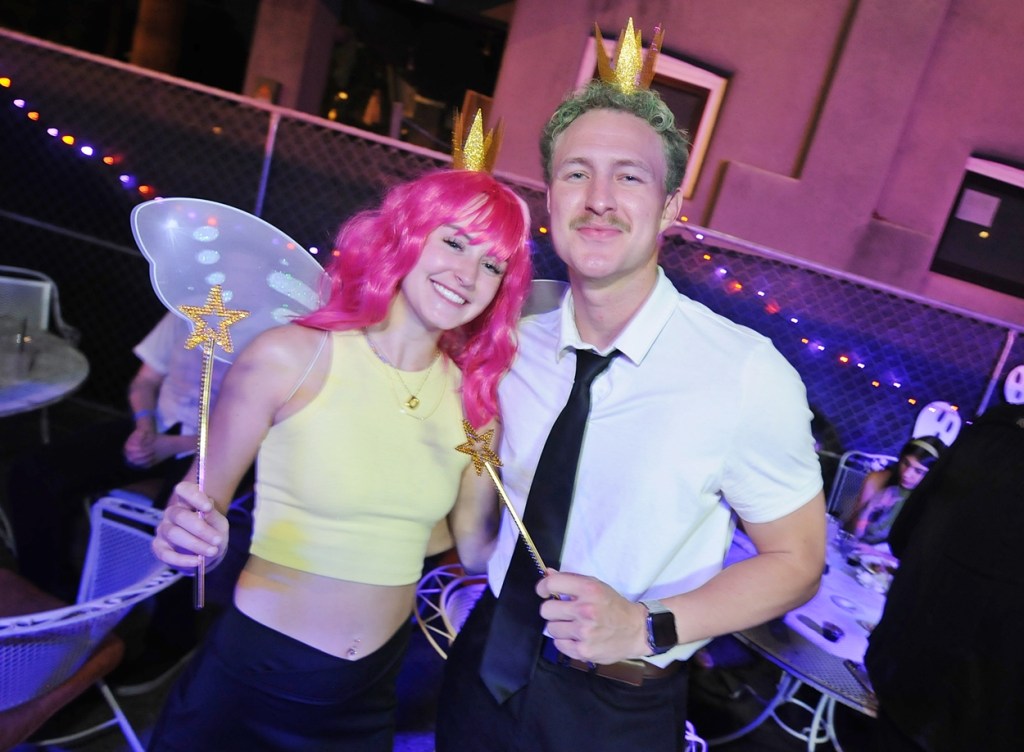 A man and a woman dressed as the Fairly OddParents.