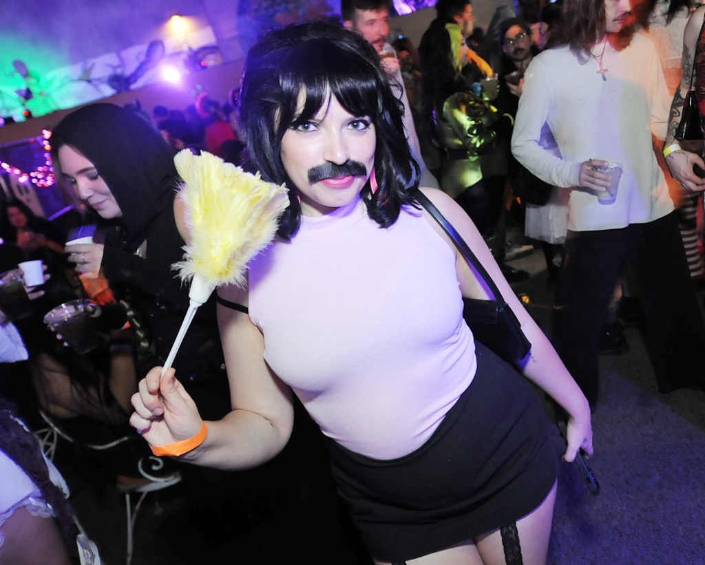 A woman dressed as Freddy Mercury.