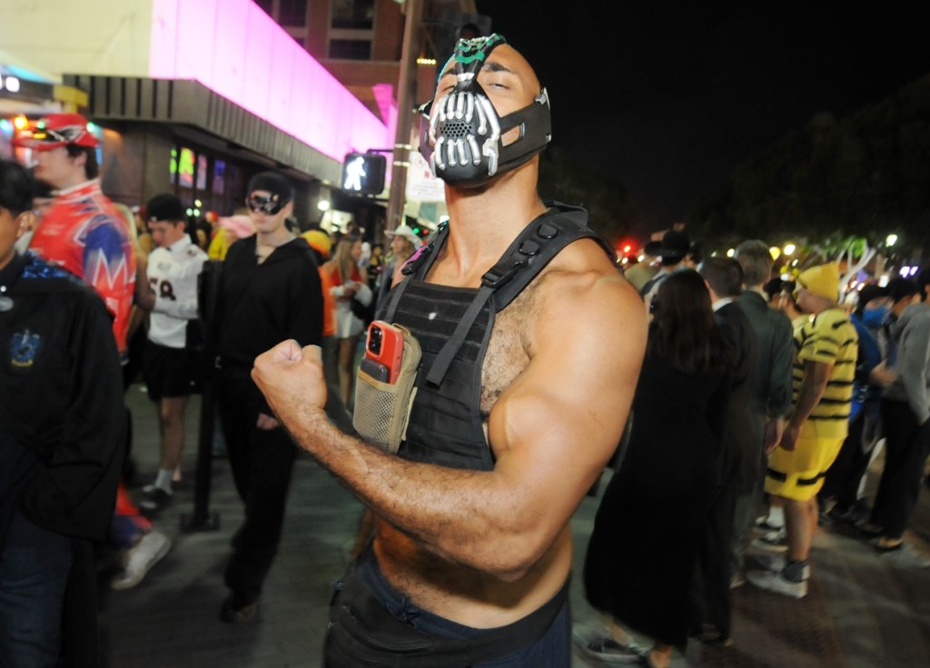 A Halloween partygoer dressed as Bane from "The Dark Knight Rises."