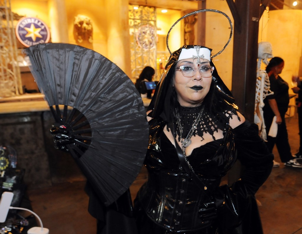 A woman dressed in a goth nun costume.