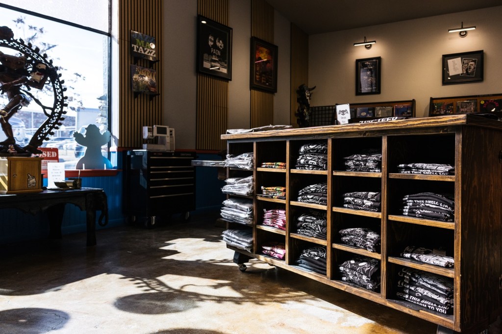 A retail store with shelves filled with t-shirts