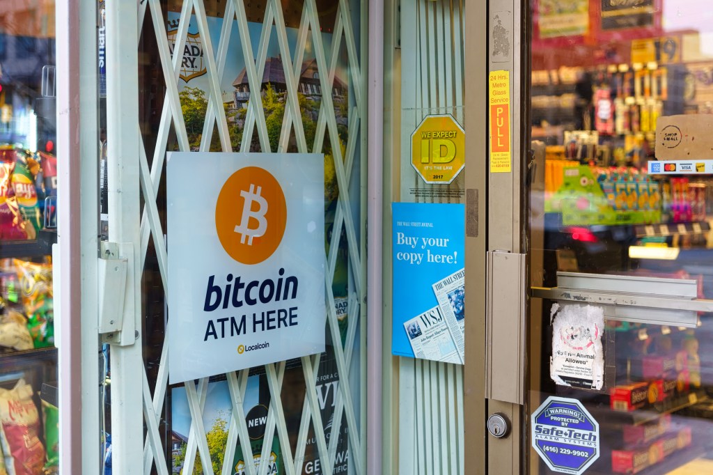 A sign advertising a Bitcoin ATM machine.