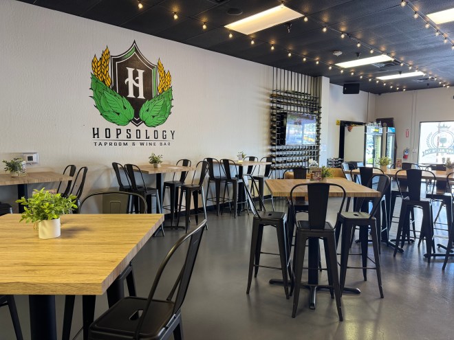 High top tables and chairs inside a taproom.