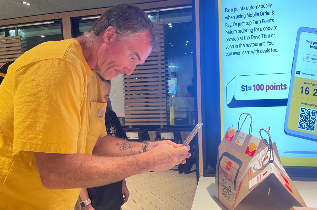 a man takes a photo of mcdonald's bags