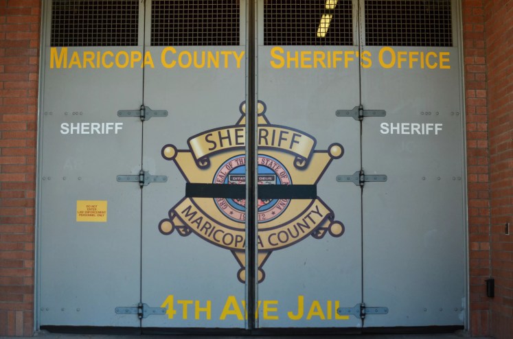 a door at the 4th avenue jail with the maricopa county sheriff's office seal on it