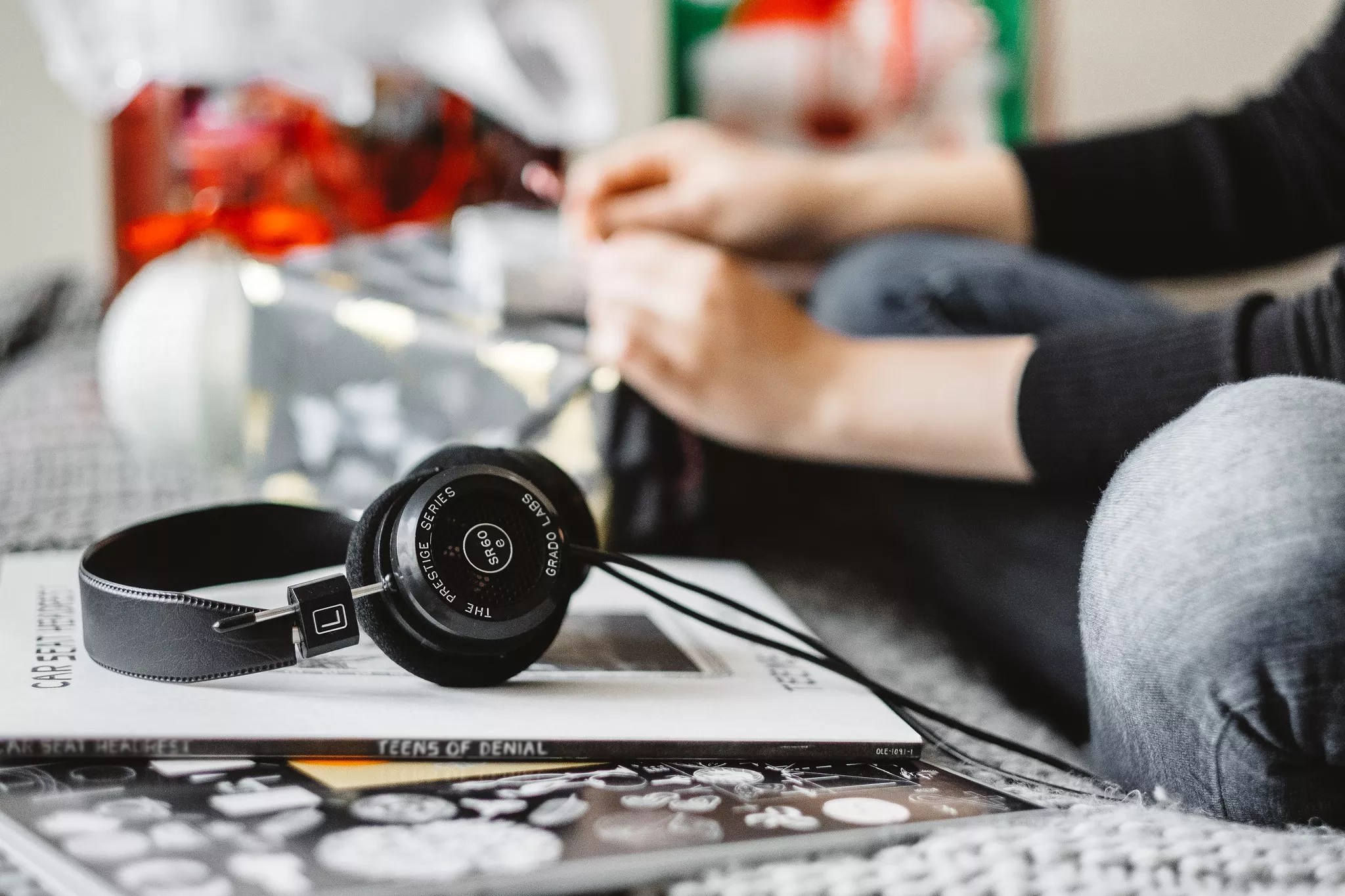 A pair of headphones sitting on a stack of books.