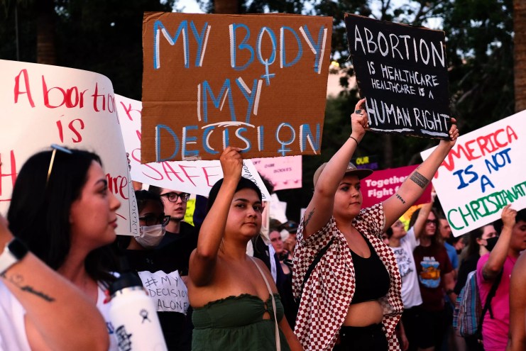 pro-abortion protesters holding signs