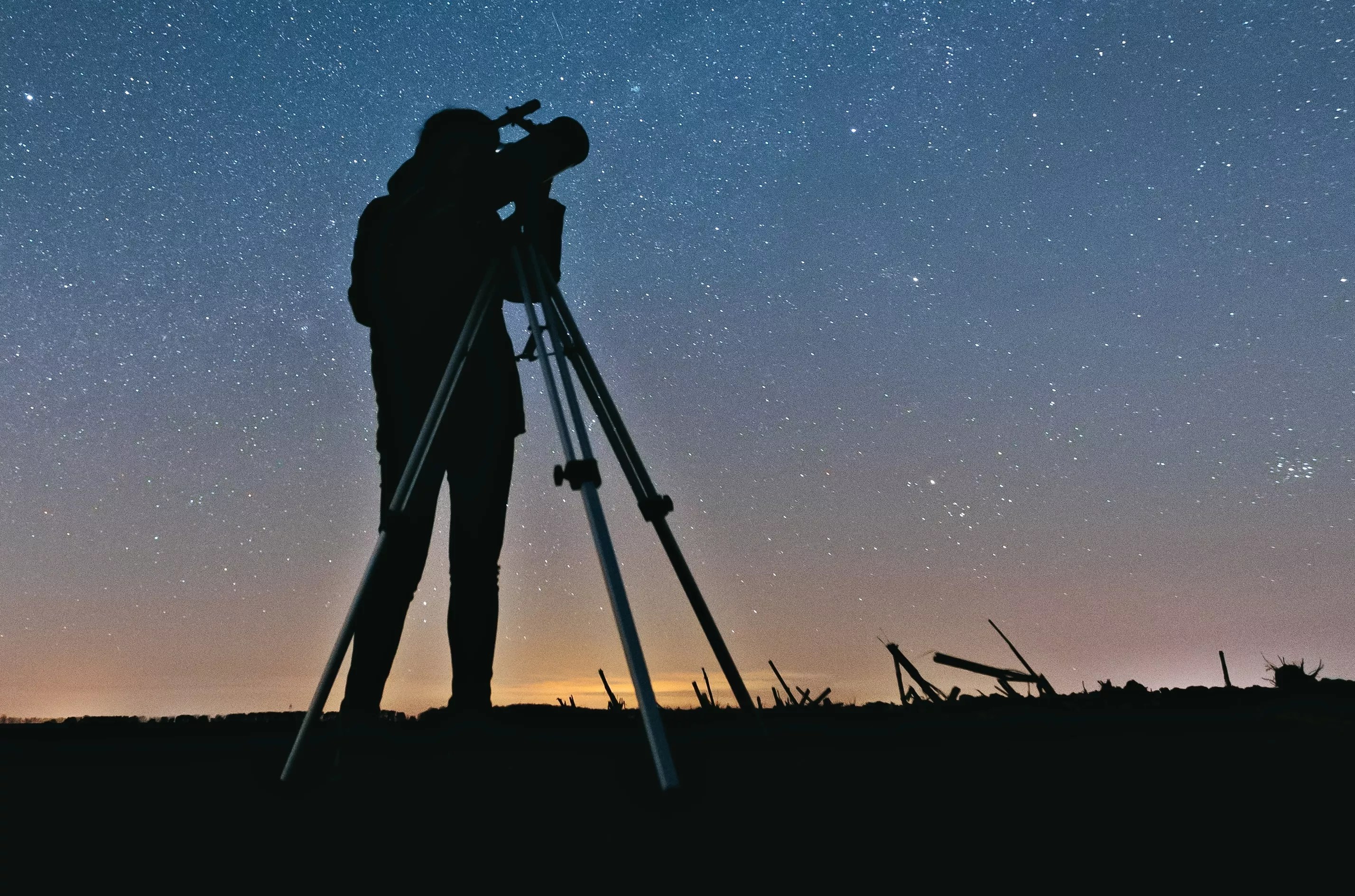 A person looking through a telescope.