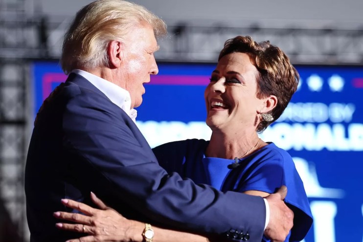 Donald Trump and Kari Lake embrace