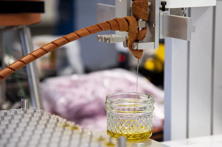 Oil dripping into a glass