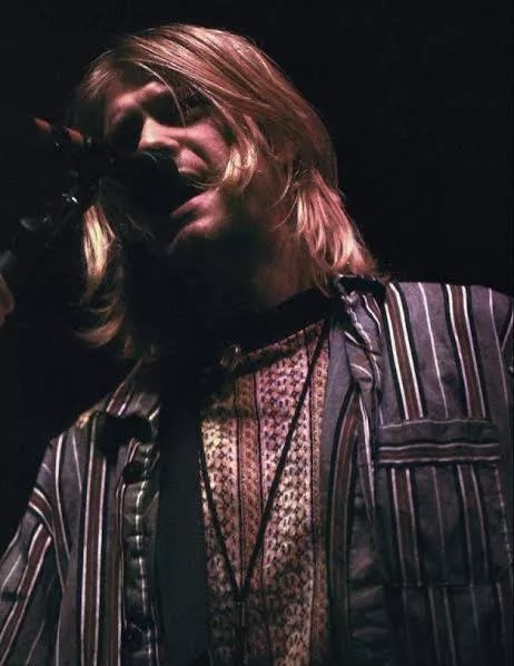 Kurt Cobain sings during a concert.
