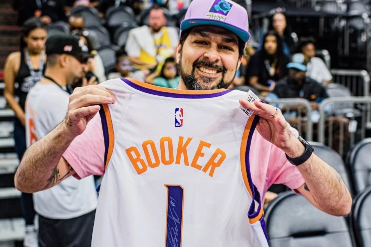 Henry Garcia with autographed Devin Booker jersey