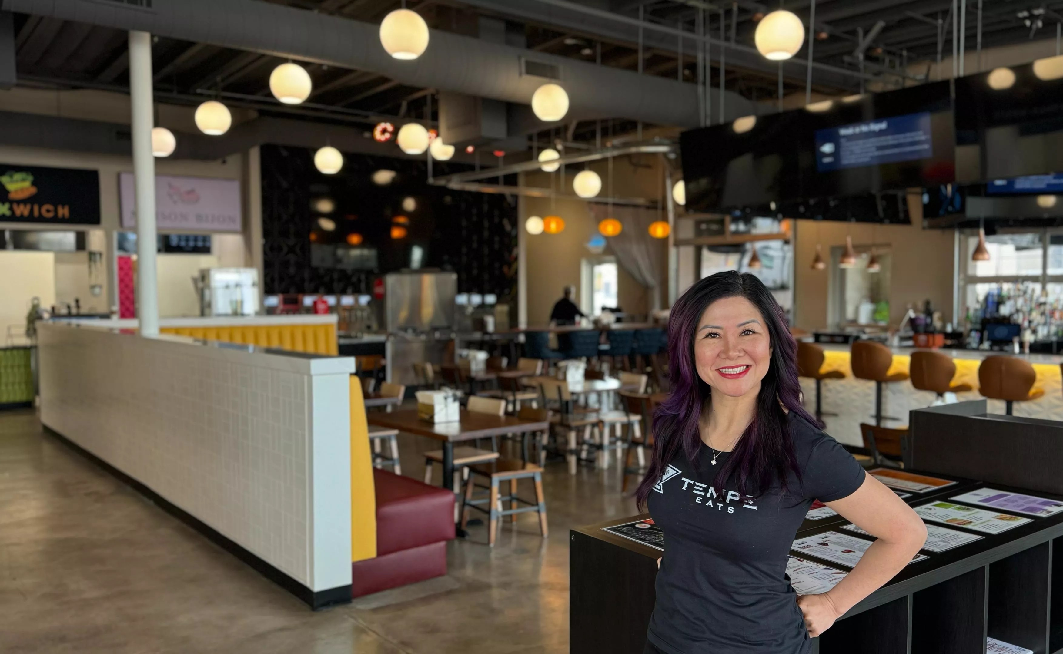 Teresa Nguyen stands in a food hall.