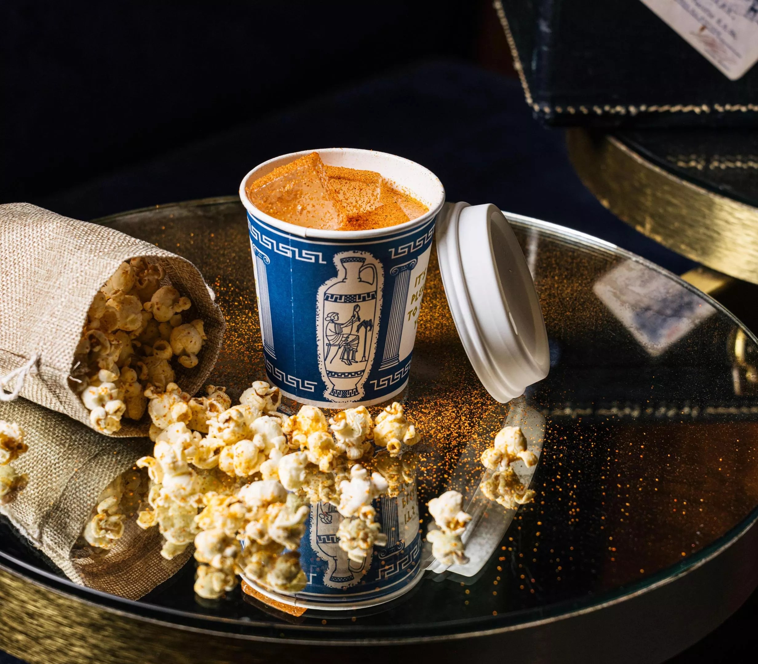 A cocktail and bag of popcorn from Platform 18.