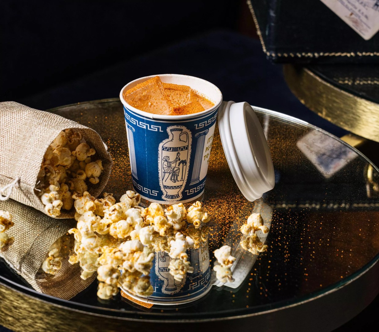 A cocktail and bag of popcorn from Platform 18.