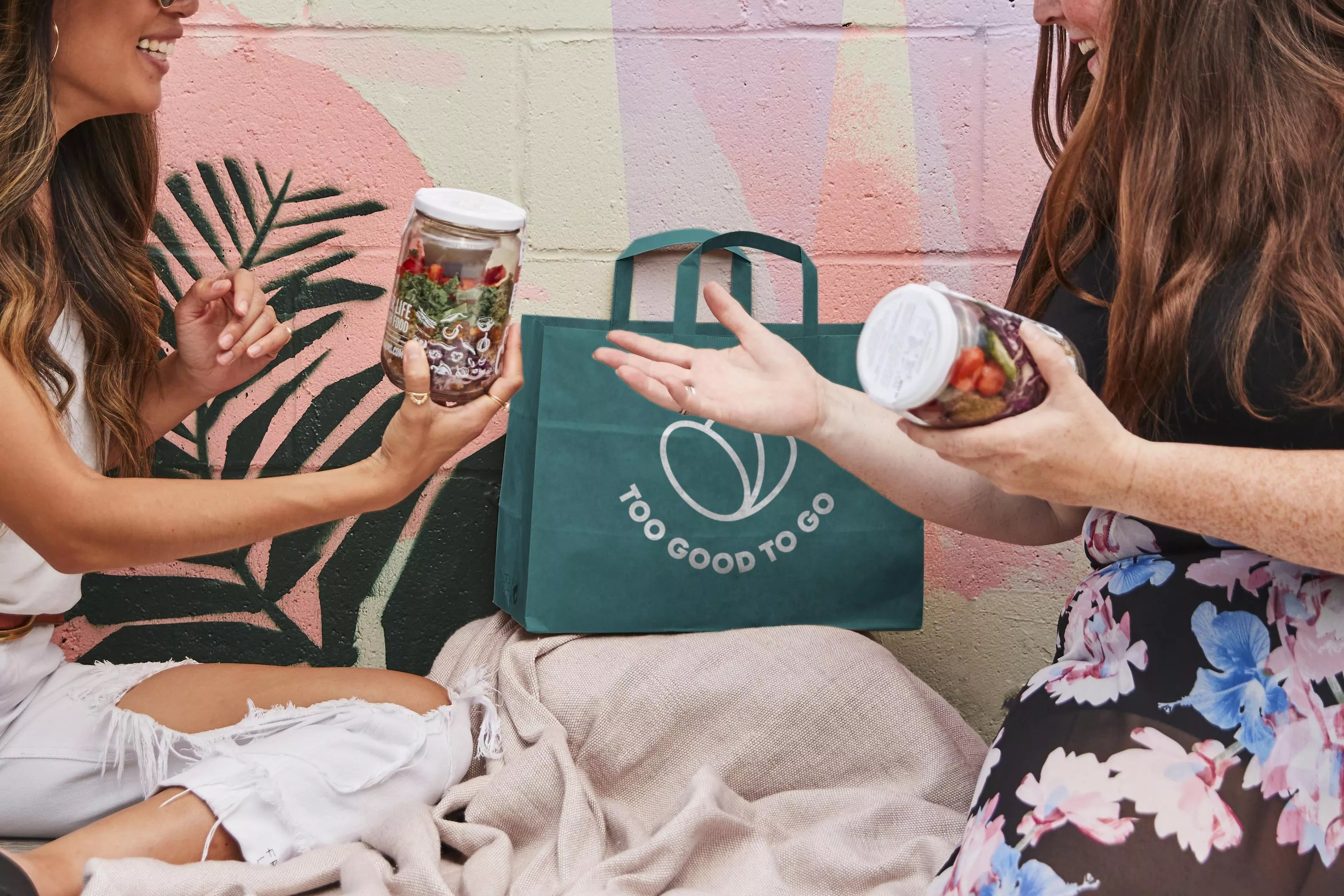 Two people with jars of food.