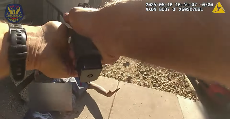 body-cam image of arms holding a gun