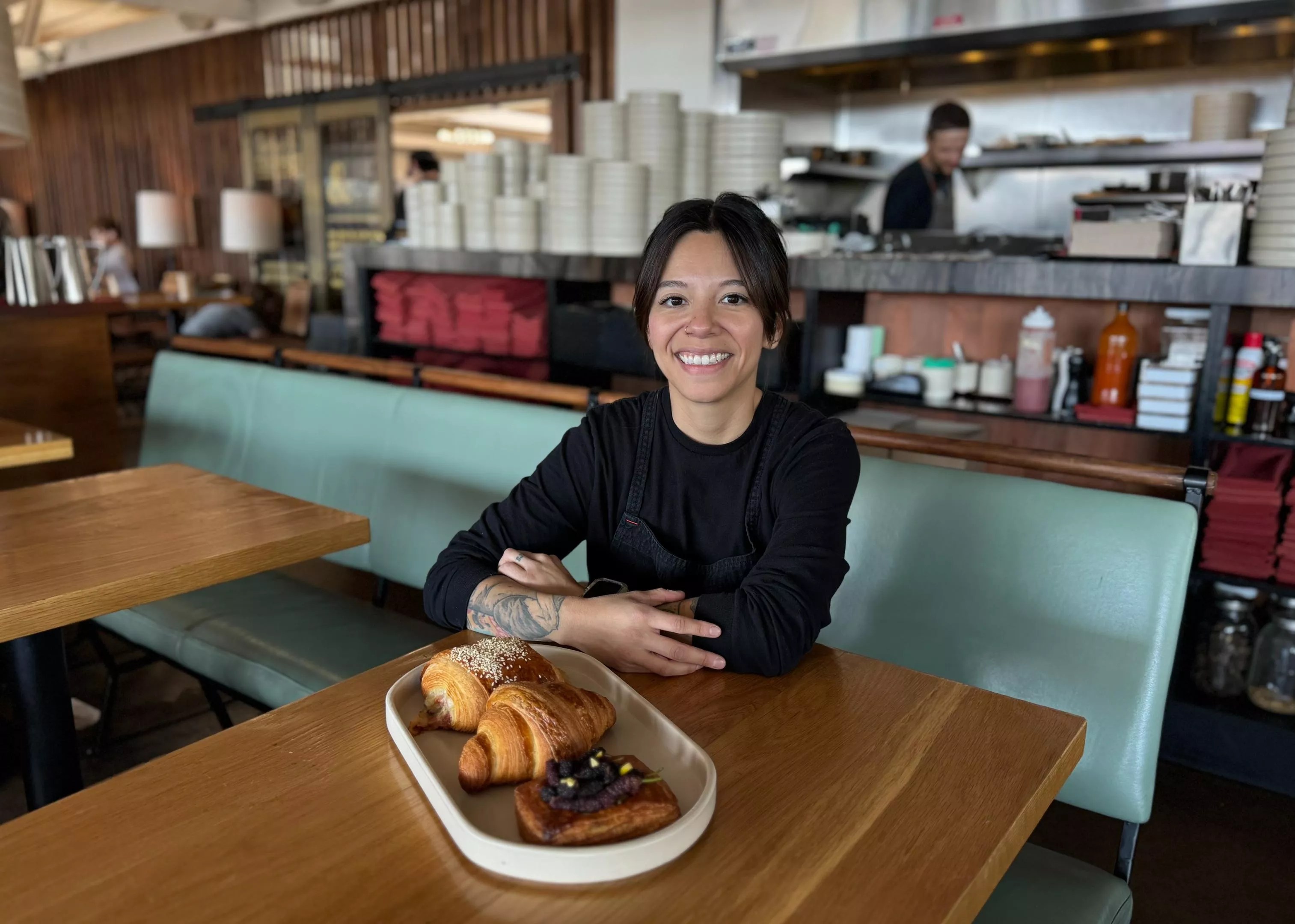 Pastry chef Crystal Kass sitting at a booth in Valentine.