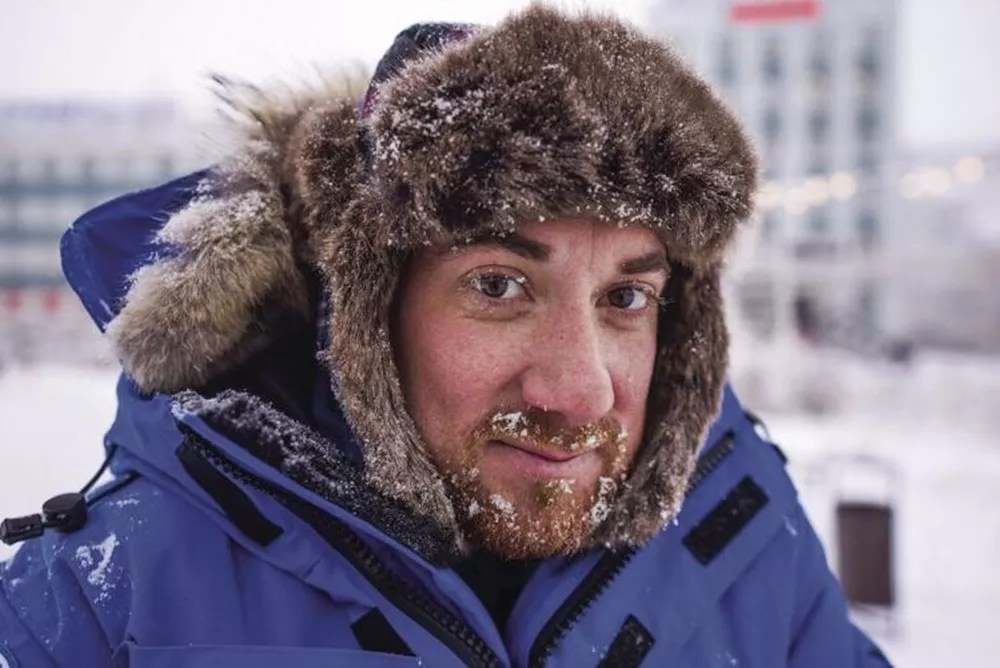 A man in cold weather with a hat.