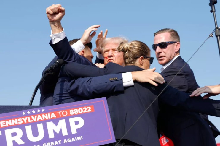 donald trump, bloodied face and surrounded by secret service members
