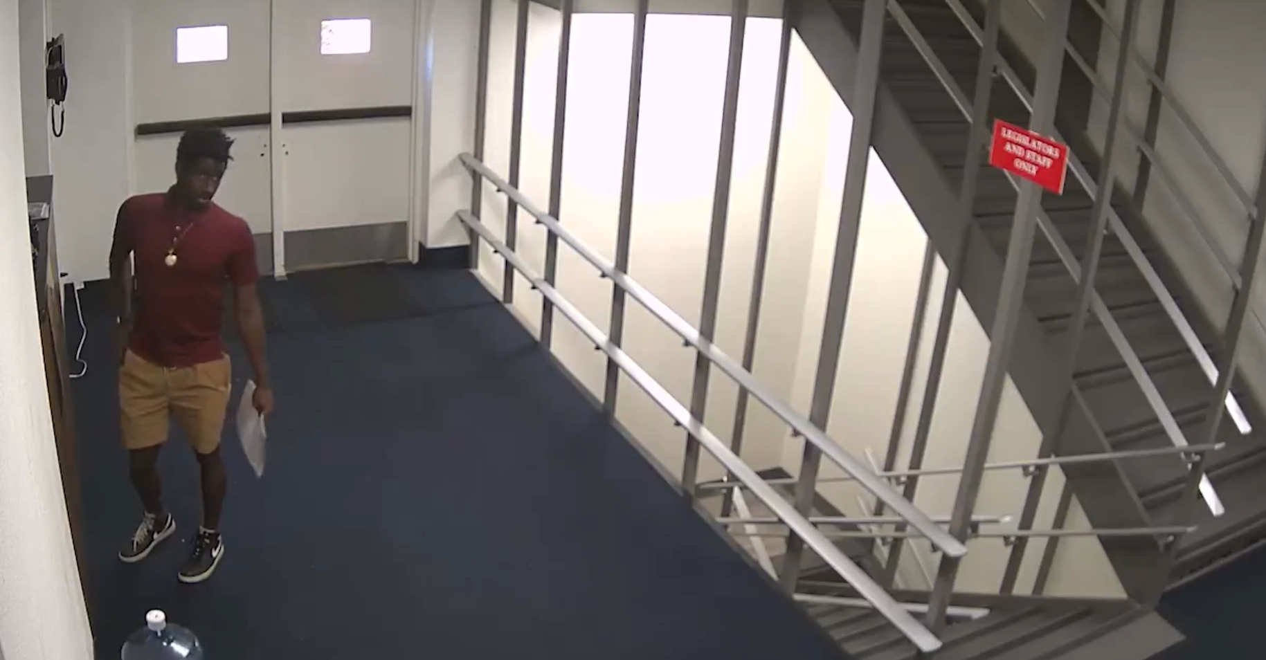 Security footage of a man in a hallway