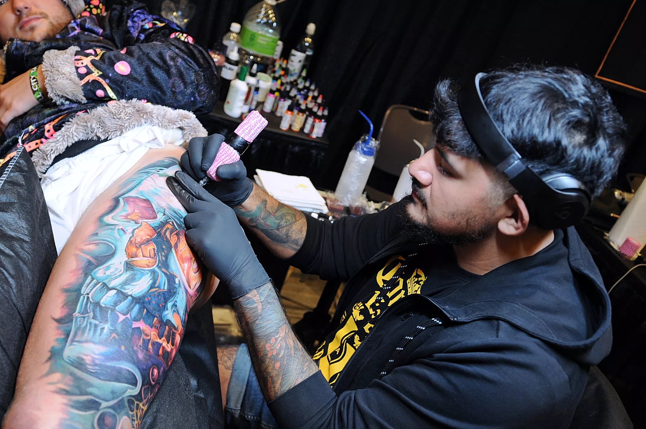 A tattoo artist creating a tattoo.
