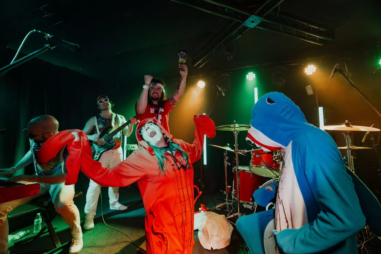 Some people in costumes on a stage.