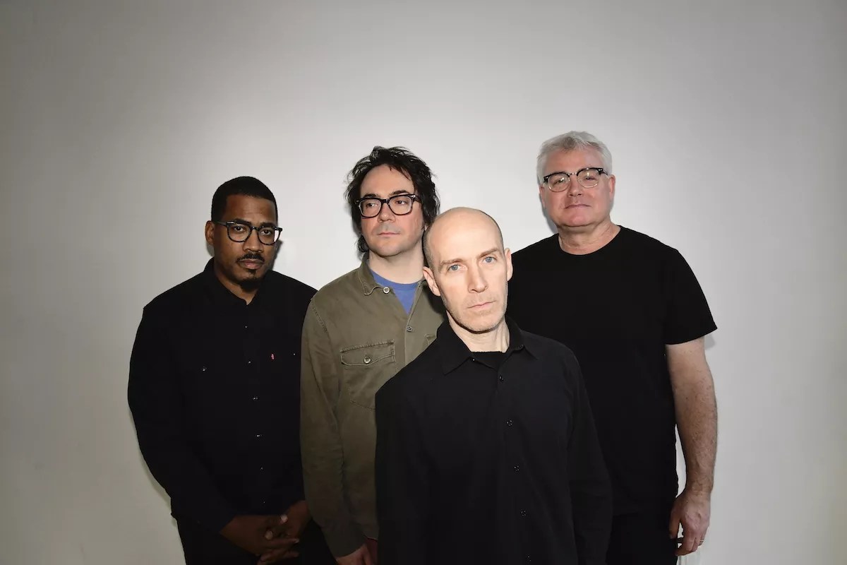 A rock band posing for the camera.