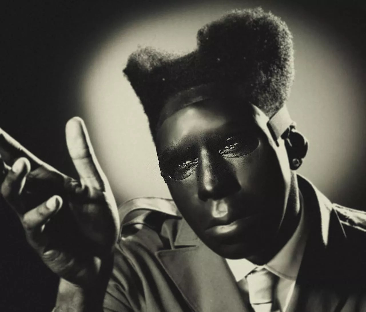 A young Black man in a mask.