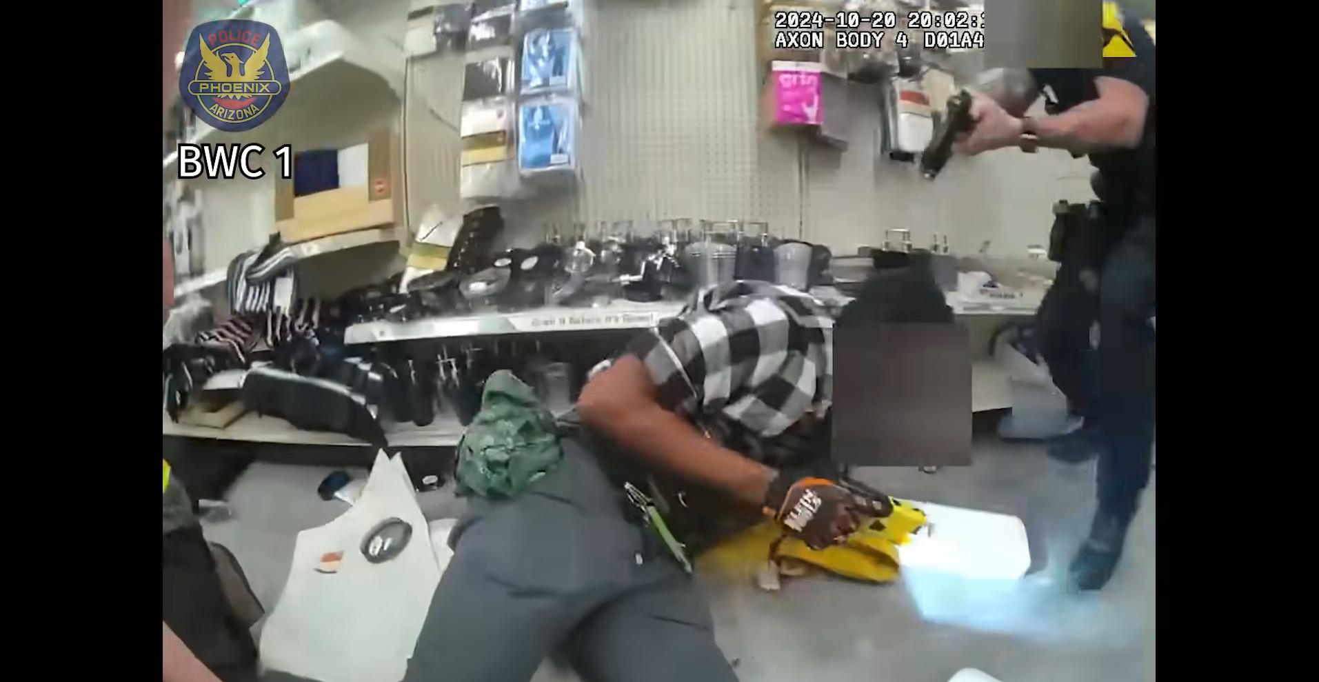 body cam footage showing a police officer pointing a gun at a man on the ground