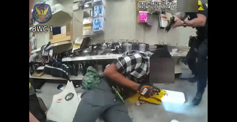 body cam footage showing a police officer pointing a gun at a man on the ground