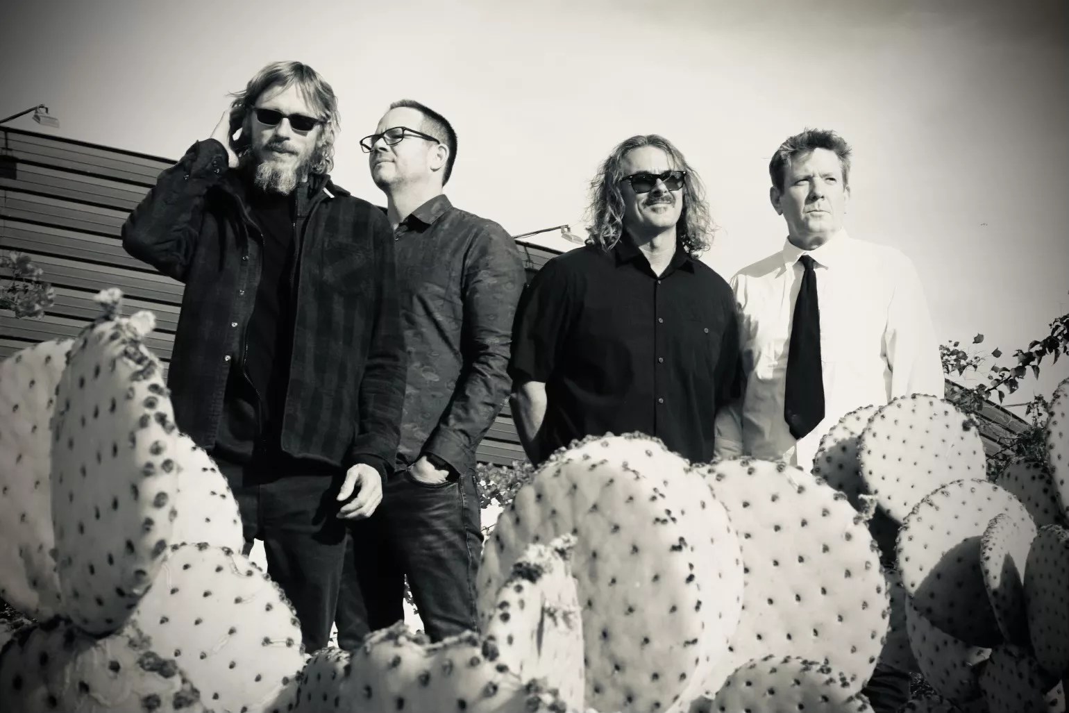 A black and white photo of a rock band.