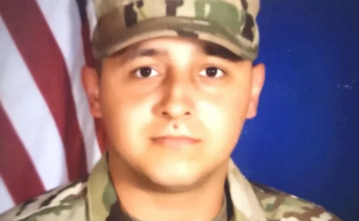 a headshot of a man in military camouflage