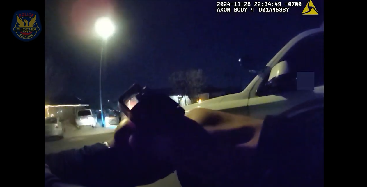 body-cam footage of two hands holding a pistol