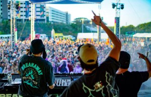 Two men perform in front of a crowd