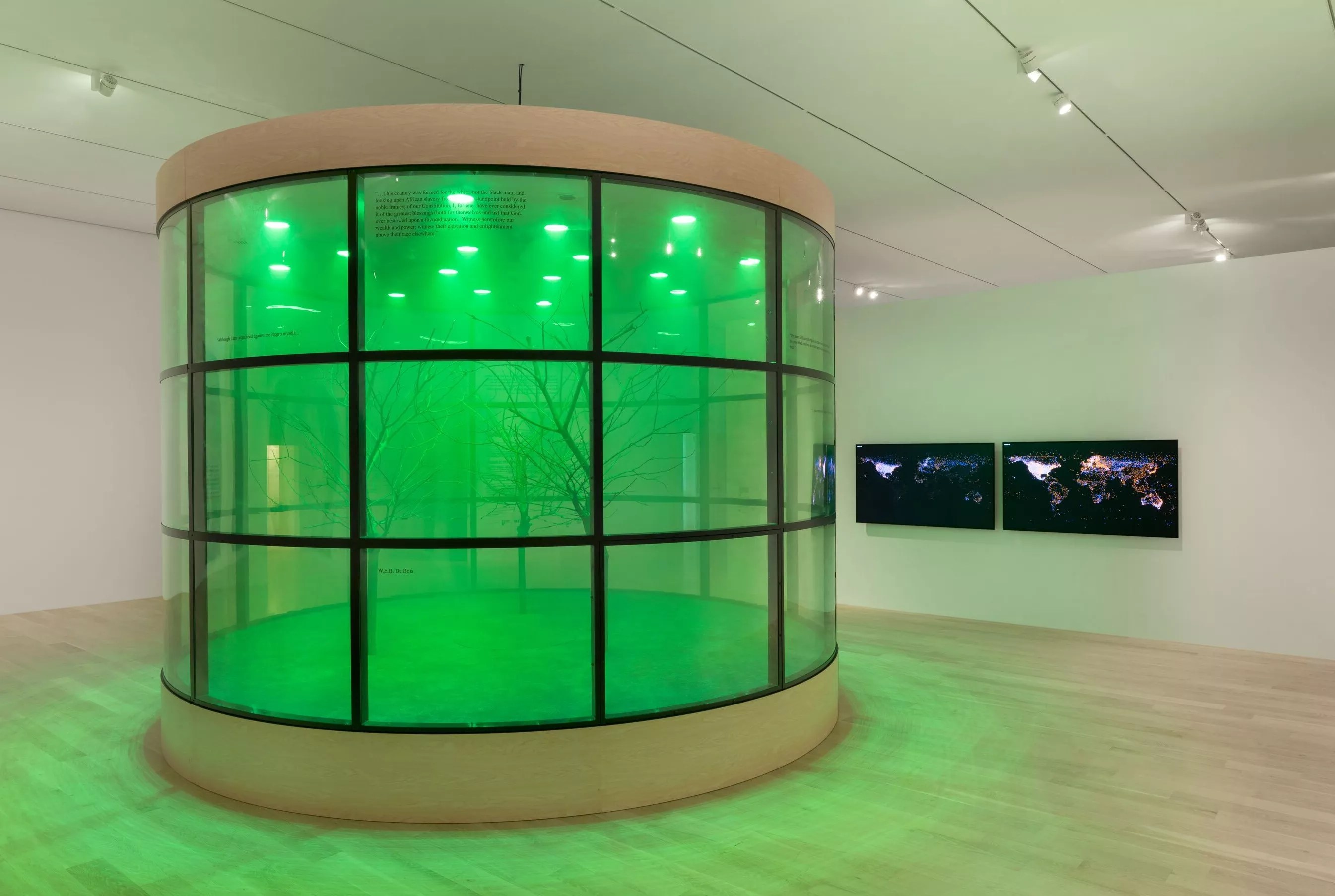 An art installation featuring a large green cylinder.