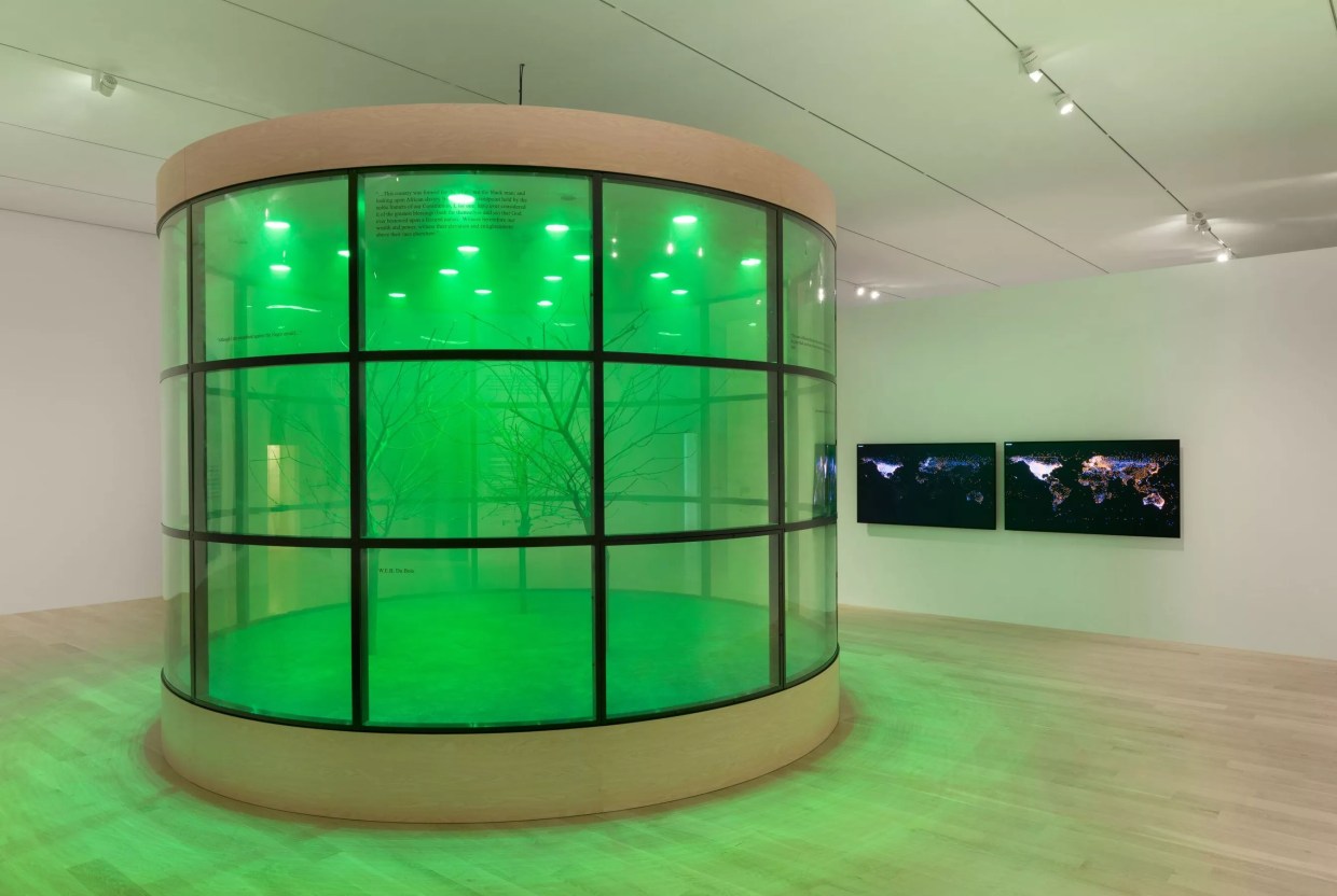 An art installation featuring a large green cylinder.