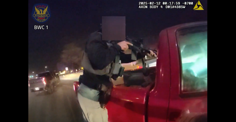 body-cam footage shoting a police officer pointing a rifle through the back window of a pickup truck