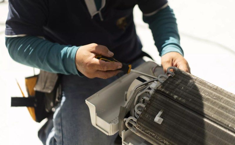 an HVAC repair person at work