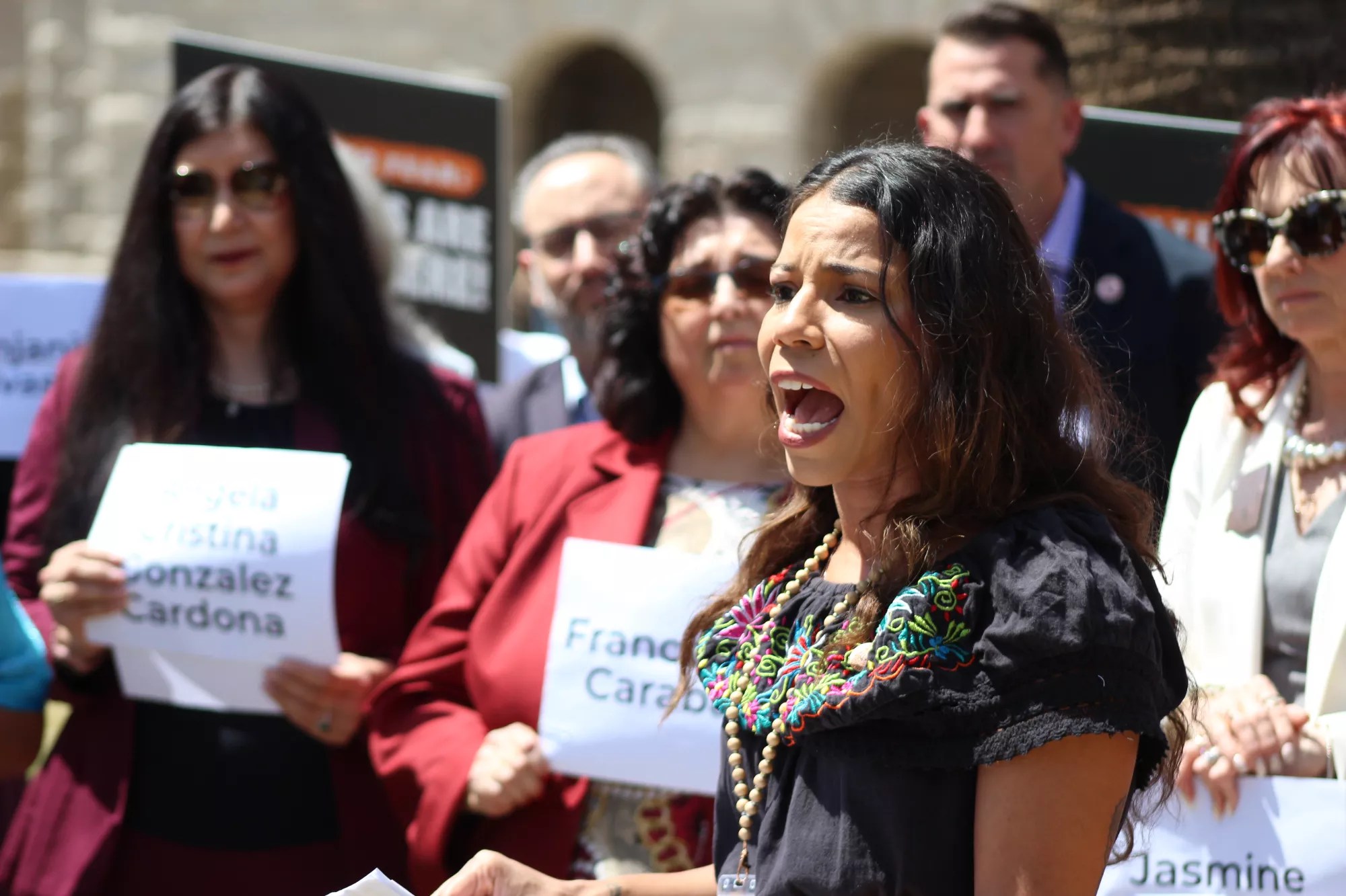 analise ortiz speaks at an outdoor press conference