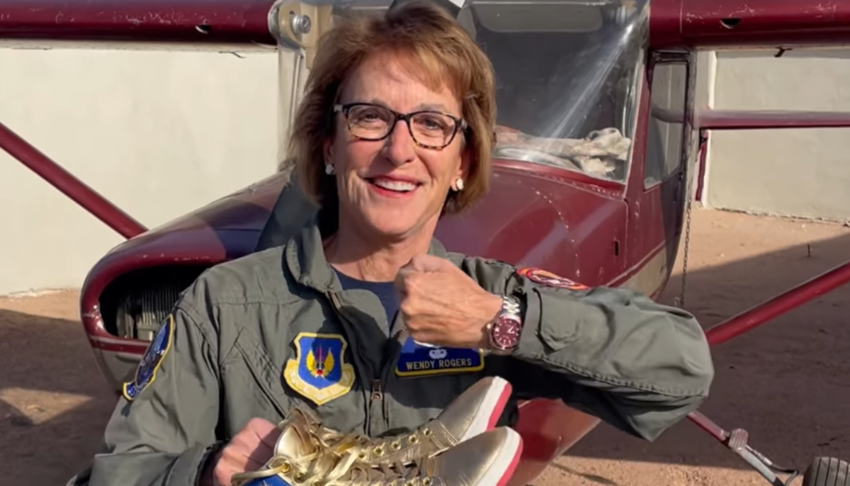 wendy rogers poses with a watch and gold sneakers