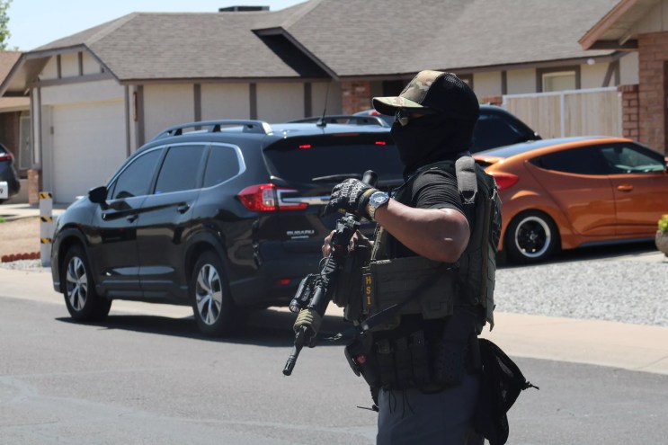 a masked HSI agent with a rifel