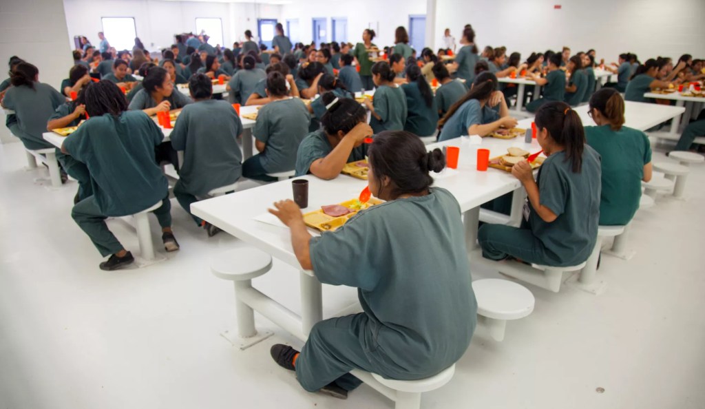 women eating in a detention center